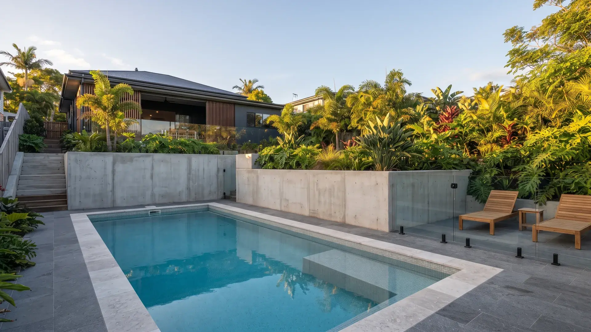 Concrete pool beside terraced retaining walls
